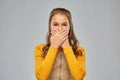 Scared teenage girl closing her mouth by hands Royalty Free Stock Photo