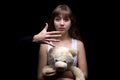 Scared teenage girl with teddy bear