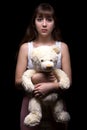 Scared teenage girl with teddy bear