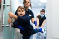 Scared teenager trying to escape from the dentist`s office. Fear of doctors concept.