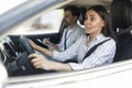 Scared unconfident woman driving car with instructor by her side Royalty Free Stock Photo