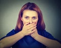 Scared woman covering her mouth with hands Royalty Free Stock Photo