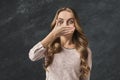 Scared woman covering mouth with hands Royalty Free Stock Photo