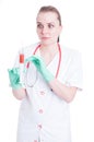 Scared woman doctor looking panicked to a syringe with needle