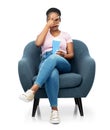 scared woman eating popcorn sitting in armchair Royalty Free Stock Photo