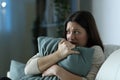 Scared woman embracing pillow at home in the night