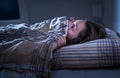 Scared woman hiding under blanket. Afraid of the dark. Unable to sleep after nightmare or bad dream. Royalty Free Stock Photo