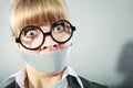 Scared woman with mouth taped shut. Censorship. Royalty Free Stock Photo