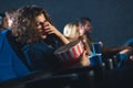 scared woman with popcorn covering eyes while watching movie Royalty Free Stock Photo