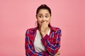 Scared woman portrait, pink background, emotion