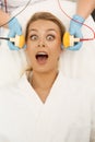 Scared woman screaming while getting facial treatment at the beauty clinic Royalty Free Stock Photo