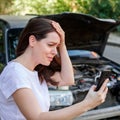 Scared woman in stress holding her head after auto crash calling to auto insurance for help. Driver woman portrait in Royalty Free Stock Photo