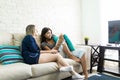 Scared Woman Watching Horror Movie On TV With Friend Royalty Free Stock Photo