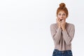 Scared, worried shocked redhead woman with curly hair in messy bun, biting fingers and stare camera frightened