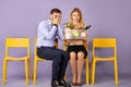 Scared young blonde woman and young man sitting together Royalty Free Stock Photo