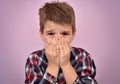Scared young boy with hands on his face Royalty Free Stock Photo