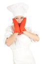 Scared young female cook with red kitchen gloves Royalty Free Stock Photo
