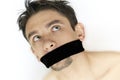 Scared young man with bandage on mouth Royalty Free Stock Photo