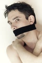 Scared young man with bandage on mouth close up Royalty Free Stock Photo