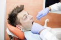 Scared young man at dentist office