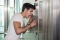 Scared young man desperate in stuck elevator Royalty Free Stock Photo