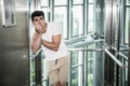 Scared young man desperate in stuck elevator Royalty Free Stock Photo
