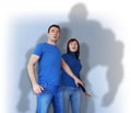 Scared young man and woman in blue wear Royalty Free Stock Photo