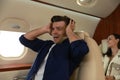 Scared young man suffering from aviophobia in airplane Royalty Free Stock Photo