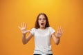 Scared young teen girl showing stop gesture against yellow background Royalty Free Stock Photo