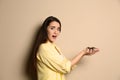 Scared young woman holding tarantula on background. Arachnophobia fear of spiders Royalty Free Stock Photo