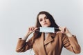 Scared young woman in medical mask standing over gray background. Royalty Free Stock Photo