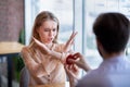 Scared young woman rejecting marriage proposal, gesturing NO, refusing to accept engagement ring at cafe Royalty Free Stock Photo