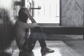 Scared young woman sitting in the corner of her bedroom, despair victim waiting for help,The concept of stopping violence Royalty Free Stock Photo