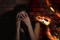 Scared young woman suffering from herpetophobia near wall. Fear or aversion to reptiles Royalty Free Stock Photo