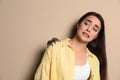 Scared young woman with tarantula on beige background. Arachnophobia fear of spiders Royalty Free Stock Photo