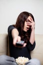 Scared young woman watching television Royalty Free Stock Photo