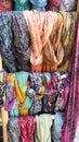 Scarf display store with colorful scarfs on a market stall Colored scarves background shop