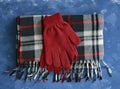 Scarf and gloves on blue background Royalty Free Stock Photo