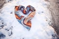 scarf swirled in the shape of a heart in the snow