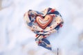 scarf swirled in the shape of a heart in the snow