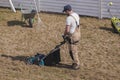 Scarifying lawn with scarifier, Man gardener scarifies the lawn and removal of old grass Royalty Free Stock Photo