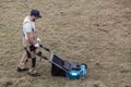 Scarifying lawn with scarifier, Man gardener scarifies the lawn and removal of old grass