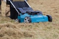 Scarifying lawn with scarifier, Man gardener scarifies the lawn and removal of old grass Royalty Free Stock Photo