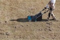 Scarifying lawn with scarifier, Man gardener scarifies the lawn and removal of old grass Royalty Free Stock Photo