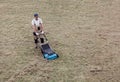 Scarifying lawn with scarifier, Man gardener scarifies the lawn and removal of old grass Royalty Free Stock Photo