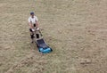 Scarifying lawn with scarifier, Man gardener scarifies the lawn and removal of old grass