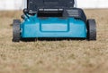 Scarifying lawn with scarifier, scarifies the lawn and removal of old grass