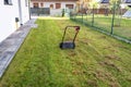 Scarifying the lawn before the winter season using an electric scarifier.