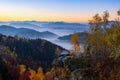 Scarlet, red, orange, yellow stripes on the horizon of the dawn sky covered with clouds in the mountains. Royalty Free Stock Photo