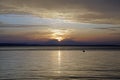 Scarlet red sunset over the sea. September in Greece. Sithonia. The sun and clouds and unusual colors. Glare on the water.